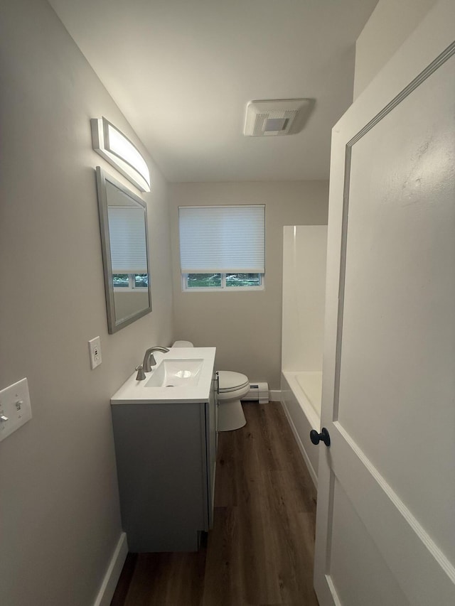 69 Heath St, Oakland, ME 04963 - full bath with vanity, wood finished floors, and baseboard heating