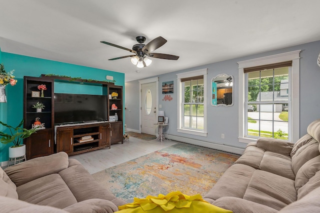 13 Dobson Rd, Berwick, ME 03901 - living area with baseboard heating, a ceiling fan, and wood finished floors