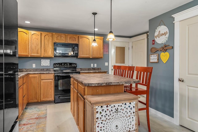 13 Dobson Rd, Berwick, ME 03901 - kitchen featuring black appliances, dark countertops, light wood finished floors, recessed lighting, and a kitchen island