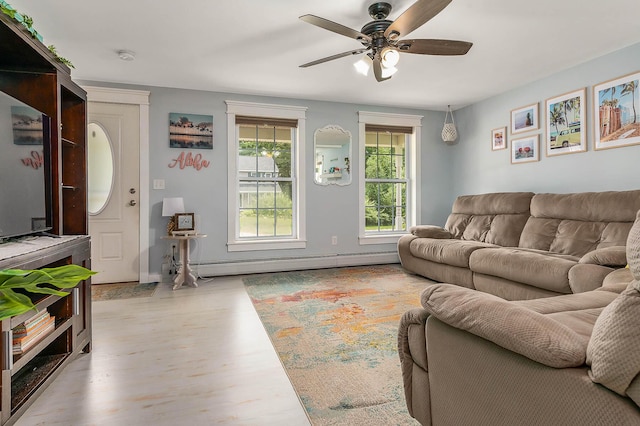 13 Dobson Rd, Berwick, ME 03901 - living room with a baseboard heating unit, a ceiling fan, and wood finished floors