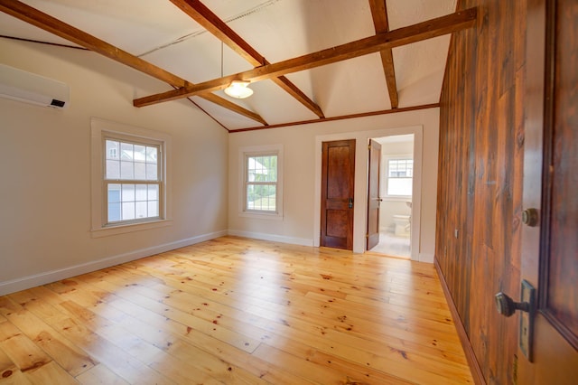 61 Shore Rd, Sebago, ME 04029 - unfurnished room with a wall mounted air conditioner and light wood-type flooring