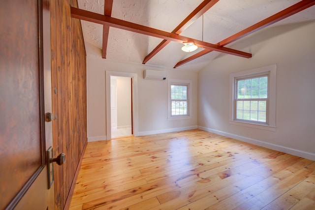 61 Shore Rd, Sebago, ME 04029 - spare room featuring a wall mounted AC and light wood finished floors