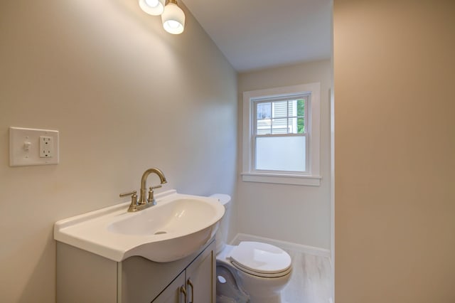 61 Shore Rd, Sebago, ME 04029 - half bath with vanity and wood finished floors