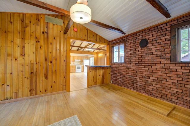 61 Shore Rd, Sebago, ME 04029 - unfurnished living room featuring brick wall, wood finished floors, and wooden walls