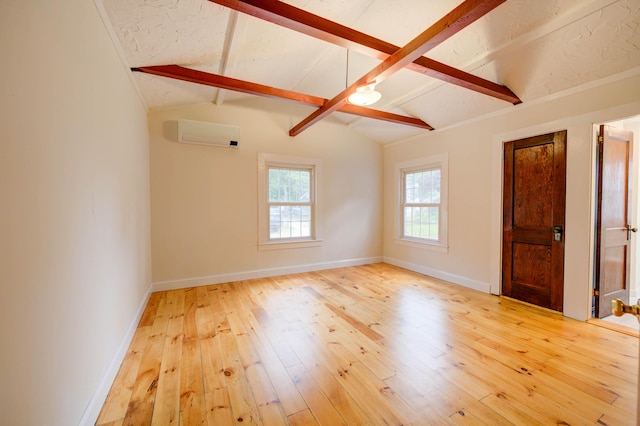 61 Shore Rd, Sebago, ME 04029 - spare room with hardwood / wood-style flooring and an AC wall unit
