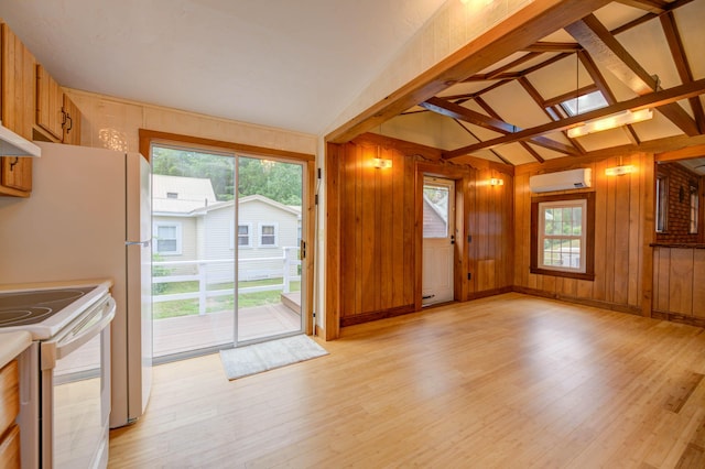 61 Shore Rd, Sebago, ME 04029 - unfurnished living room featuring a wall mounted air conditioner, light wood finished floors, vaulted ceiling, wooden walls, and plenty of natural light