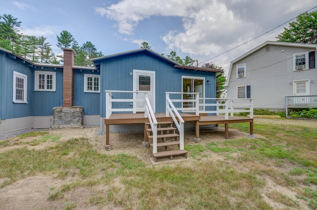 61 Shore Rd, Sebago, ME 04029 - rear view of house featuring a deck and a chimney