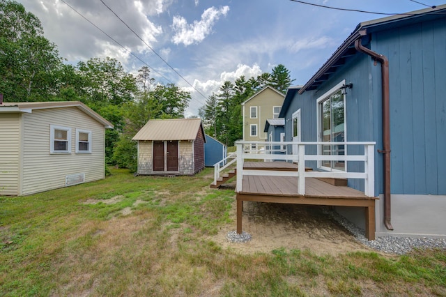 61 Shore Rd, Sebago, ME 04029 - view of green lawn featuring a wooden deck and a shed