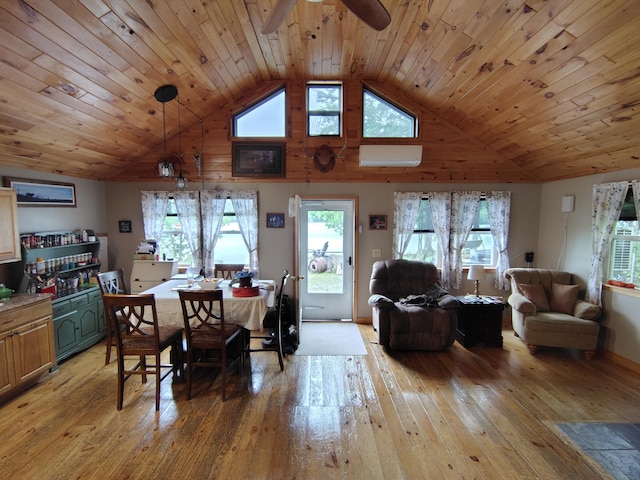 114 E Shore Rd, Benedicta Twp, ME 04733 - dining space featuring light wood-type flooring, a wall unit AC, a ceiling fan, healthy amount of natural light, and high vaulted ceiling