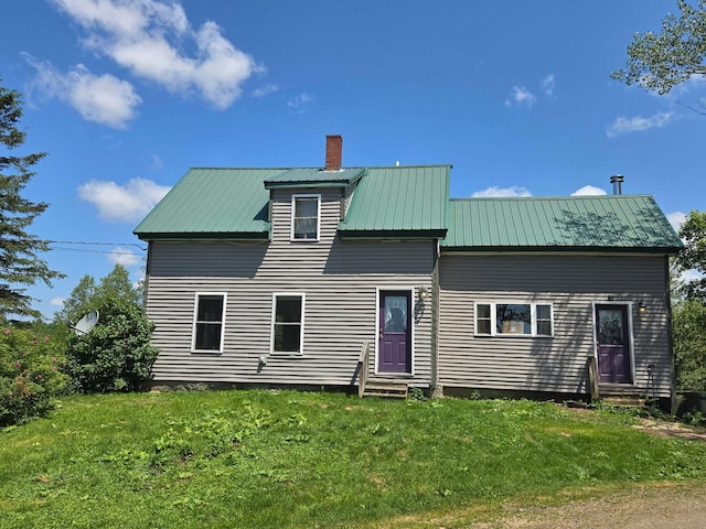 471 Chandler Hill Rd, Ripley, ME 04930 - rear view of house featuring entry steps, a chimney, a lawn, and a metal roof