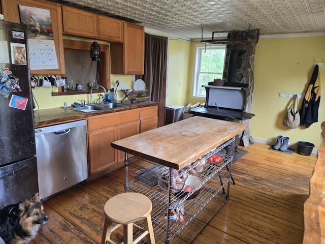 471 Chandler Hill Rd, Ripley, ME 04930 - kitchen with dishwasher, freestanding refrigerator, dark wood-style floors, an ornate ceiling, and brown cabinetry