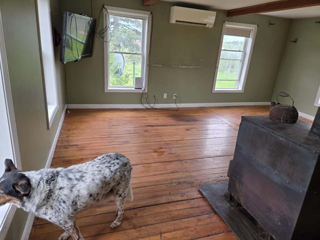 471 Chandler Hill Rd, Ripley, ME 04930 - living area with an AC wall unit, hardwood / wood-style flooring, plenty of natural light, and beamed ceiling