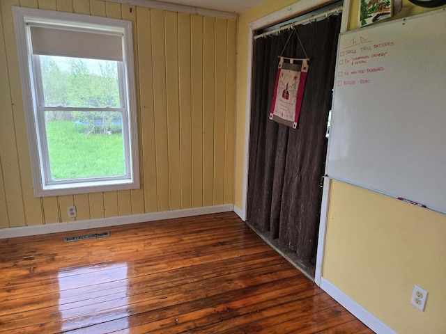 471 Chandler Hill Rd, Ripley, ME 04930 - empty room featuring wood finished floors, healthy amount of natural light, and wood walls