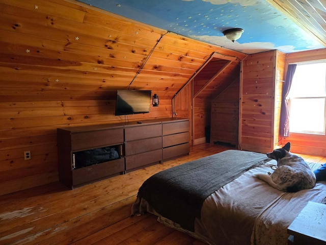 471 Chandler Hill Rd, Ripley, ME 04930 - bedroom with lofted ceiling, light wood-style floors, wooden walls, and a fireplace