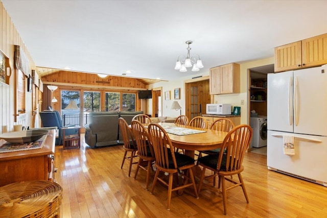 48 Green Bay Rd, Newfield, ME 04095 - dining space with lofted ceiling, light wood-type flooring, a chandelier, and washer / clothes dryer