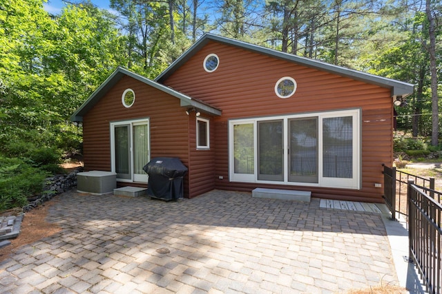 48 Green Bay Rd, Newfield, ME 04095 - back of property featuring a patio area, faux log siding, and entry steps