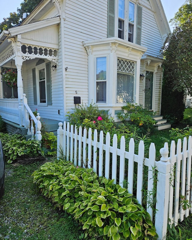 5 Purchase St, Rockland, ME 04841 - view of side of property with a fenced front yard and covered porch