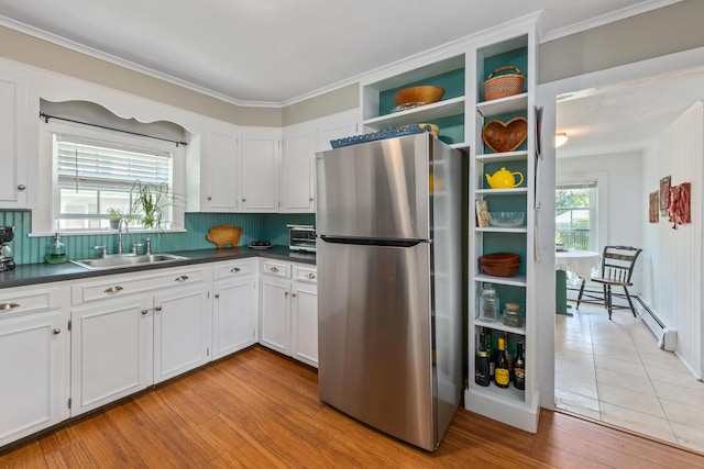 5 Purchase St, Rockland, ME 04841 - kitchen with freestanding refrigerator, a baseboard radiator, dark countertops, tasteful backsplash, and open shelves