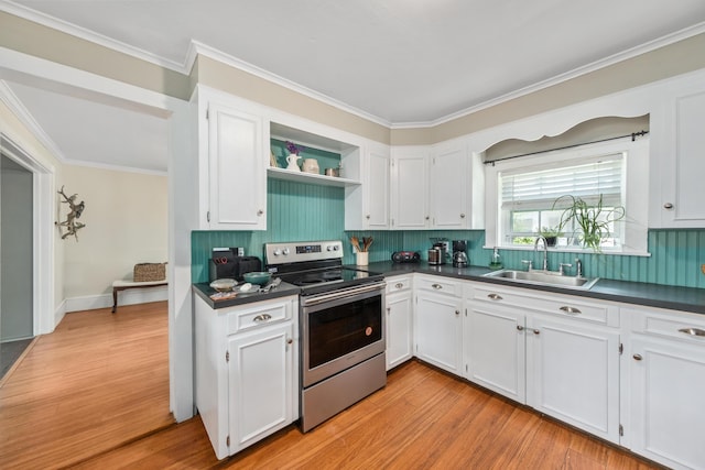 5 Purchase St, Rockland, ME 04841 - kitchen with stainless steel electric stove, dark countertops, white cabinets, light wood-type flooring, and decorative backsplash