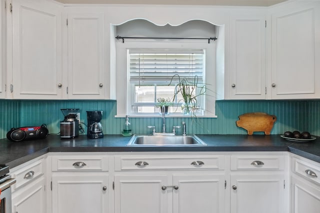 5 Purchase St, Rockland, ME 04841 - kitchen featuring dark countertops, white cabinetry, and range