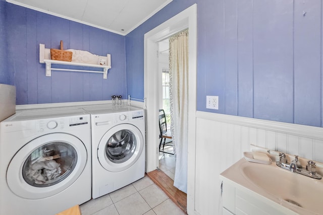 5 Purchase St, Rockland, ME 04841 - laundry room with washing machine and clothes dryer, ornamental molding, light tile patterned floors, and a decorative wall