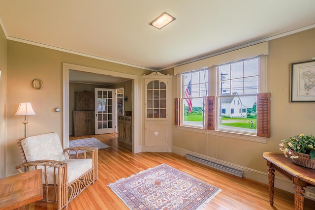 69 W Meadow Rd, Rockland, ME 04841 - sitting room with baseboard heating, crown molding, and light wood-style flooring