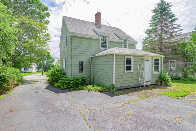 69 W Meadow Rd, Rockland, ME 04841 - back of property with a chimney and a shingled roof