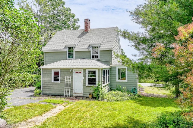 69 W Meadow Rd, Rockland, ME 04841 - view of front of house featuring a chimney, a front yard, and a shingled roof