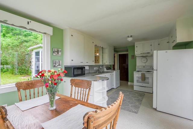 69 W Meadow Rd, Rockland, ME 04841 - kitchen featuring white appliances, washer / clothes dryer, under cabinet range hood, and light countertops