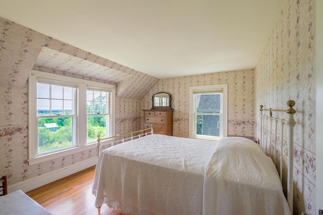 69 W Meadow Rd, Rockland, ME 04841 - bedroom featuring wallpapered walls, wood finished floors, and multiple windows