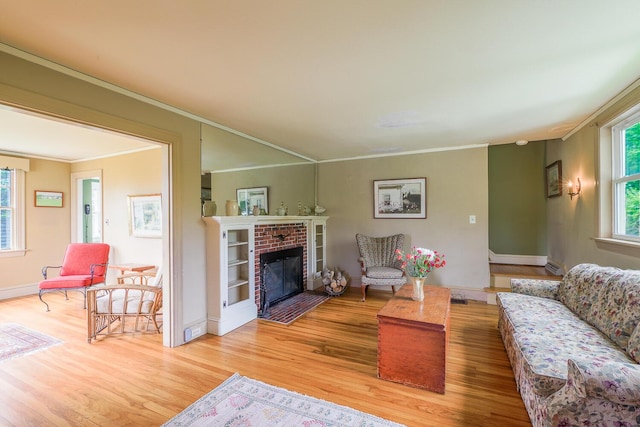 69 W Meadow Rd, Rockland, ME 04841 - living area with light wood-type flooring, ornamental molding, and a fireplace