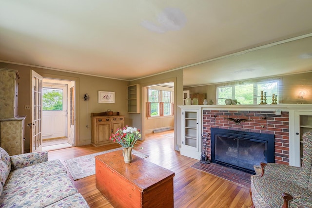 69 W Meadow Rd, Rockland, ME 04841 - living room featuring ornamental molding, wood finished floors, a baseboard heating unit, and a fireplace