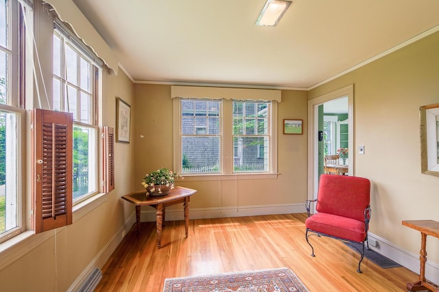 69 W Meadow Rd, Rockland, ME 04841 - living area with wood finished floors, healthy amount of natural light, and ornamental molding