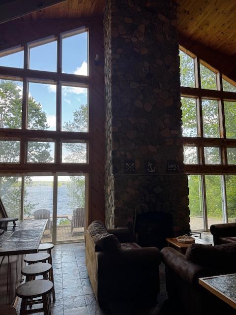 24 Cliffside Dr, Saint Albans, ME 04971 - living area featuring high vaulted ceiling, wood ceiling, and stone tile flooring
