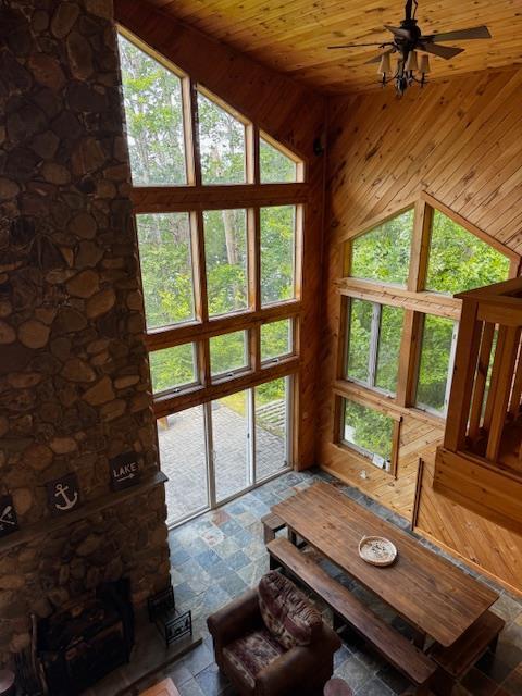 24 Cliffside Dr, Saint Albans, ME 04971 - living room with lofted ceiling, wood ceiling, stone finish flooring, and wood walls