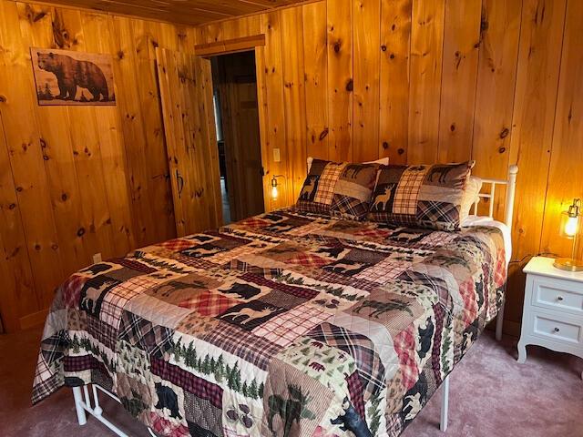 24 Cliffside Dr, Saint Albans, ME 04971 - bedroom featuring wooden walls and carpet floors