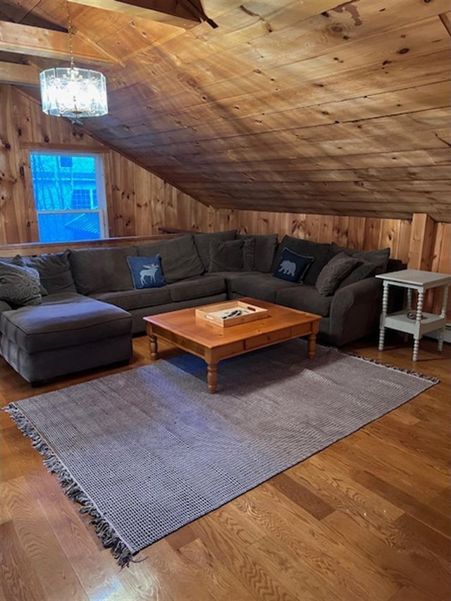 24 Cliffside Dr, Saint Albans, ME 04971 - living area featuring wood walls, lofted ceiling, wood ceiling, hardwood / wood-style flooring, and a chandelier
