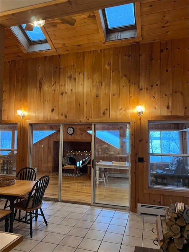24 Cliffside Dr, Saint Albans, ME 04971 - doorway with a skylight, baseboard heating, light tile patterned floors, wooden walls, and wood ceiling