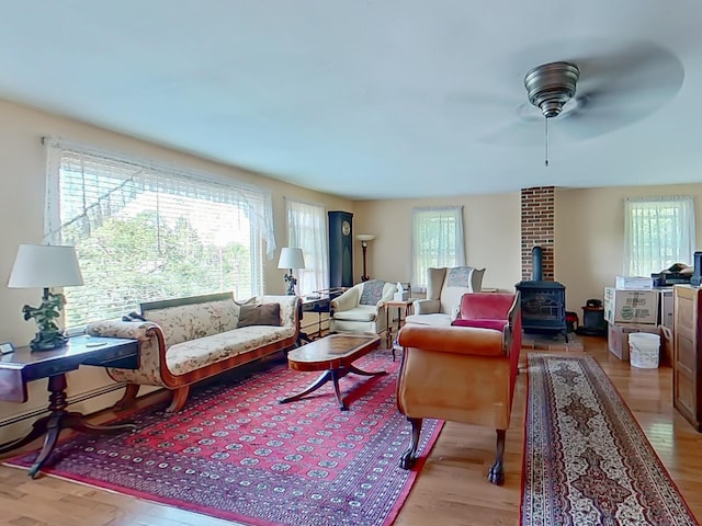 63 N Shore Dr, Owls Head, ME 04854 - living area featuring plenty of natural light, a wood stove, and light wood finished floors