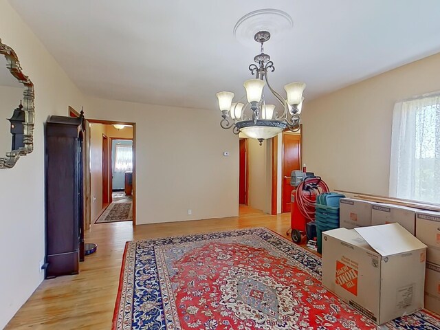63 N Shore Dr, Owls Head, ME 04854 - dining space featuring a chandelier and light wood-type flooring