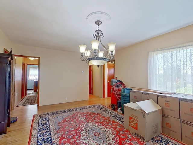 63 N Shore Dr, Owls Head, ME 04854 - dining space featuring a chandelier and light wood-style flooring