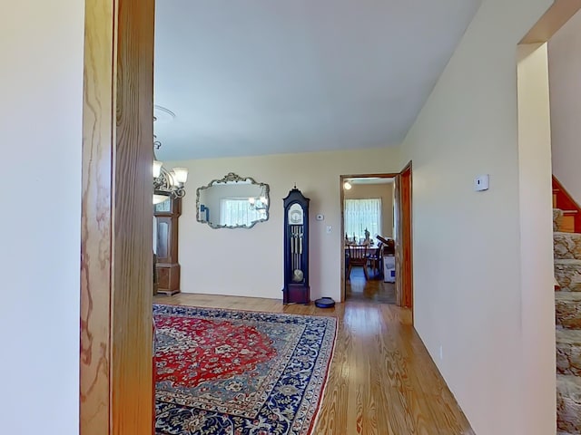63 N Shore Dr, Owls Head, ME 04854 - corridor featuring wood finished floors, a chandelier, and stairway