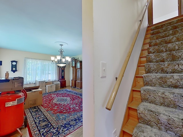 63 N Shore Dr, Owls Head, ME 04854 - stairs with a chandelier and wood finished floors