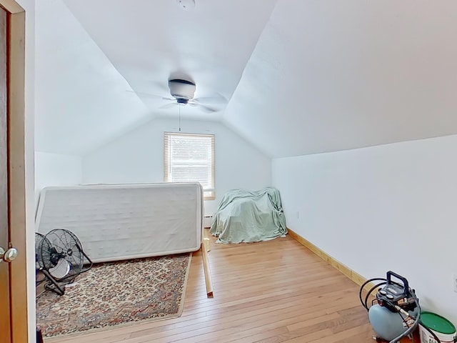 63 N Shore Dr, Owls Head, ME 04854 - bedroom featuring wood-type flooring, lofted ceiling, ceiling fan, and a baseboard radiator