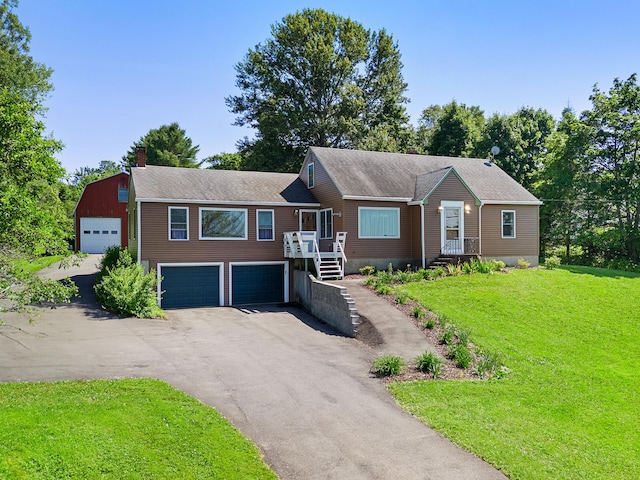 63 N Shore Dr, Owls Head, ME 04854 - view of front of house with driveway, a front lawn, a chimney, and a shingled roof
