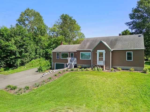 63 N Shore Dr, Owls Head, ME 04854 - view of front of home featuring a chimney, driveway, a garage, a front lawn, and a shingled roof