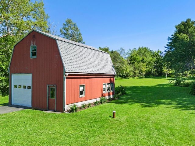 63 N Shore Dr, Owls Head, ME 04854 - view of side of home with a barn, a gambrel roof, a detached garage, an outbuilding, and driveway