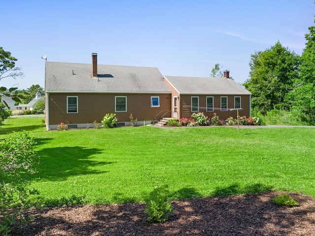 63 N Shore Dr, Owls Head, ME 04854 - rear view of house with a chimney and a lawn