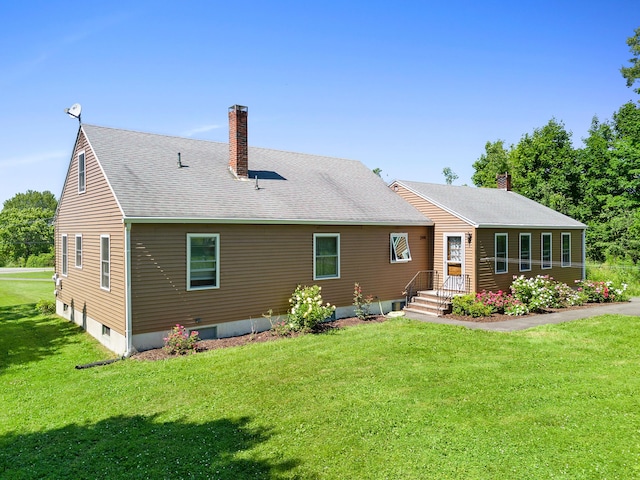 63 N Shore Dr, Owls Head, ME 04854 - back of house with a chimney, a yard, and a shingled roof