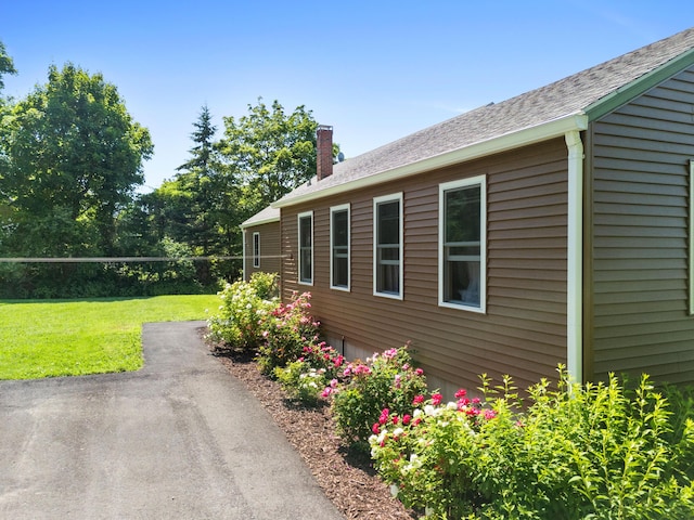 63 N Shore Dr, Owls Head, ME 04854 - view of side of property with a chimney, a yard, and a patio area